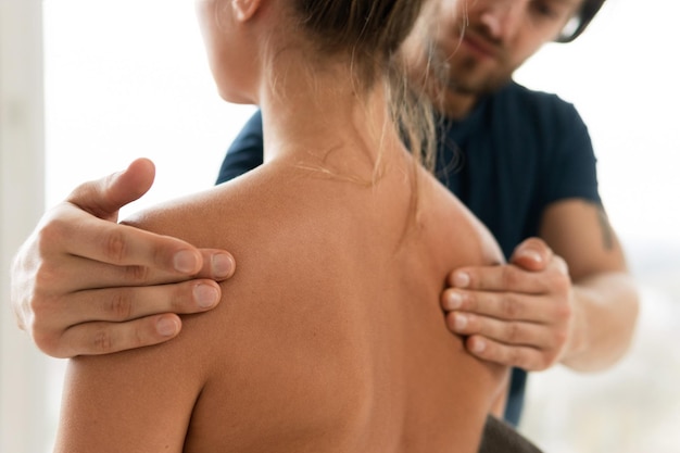 Masseur man doing back massage for his woman client