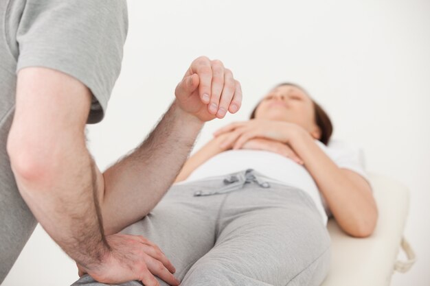 Photo masseur massaging the thigh of a woman