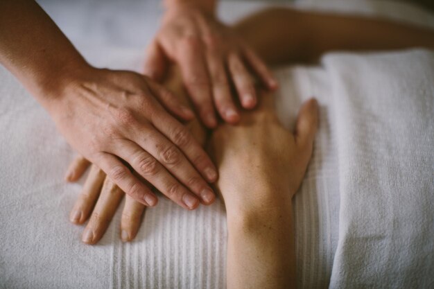 Photo masseuse massaging the hands