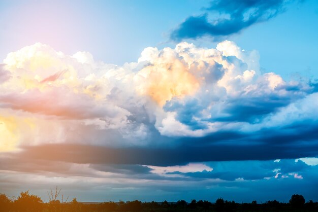 Massive clouds on evening sky with sun beams