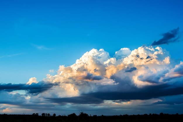 Massive clouds on evening sky with sun beams