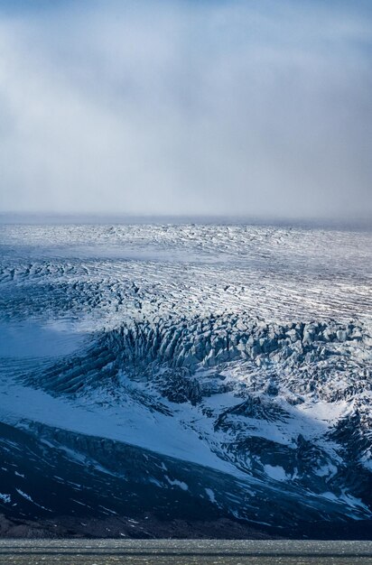 Massive glacier over the lake, long shot