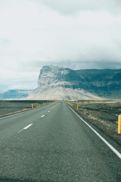 Massive mountain with canyon on iceland end of an infinite road\
view from the road during a trip through icelandic wild areas boho\
backpacking traveling style nature background concept colorful