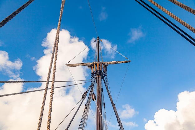 Mast with ropes and ladder on an old wooden ship bottom view