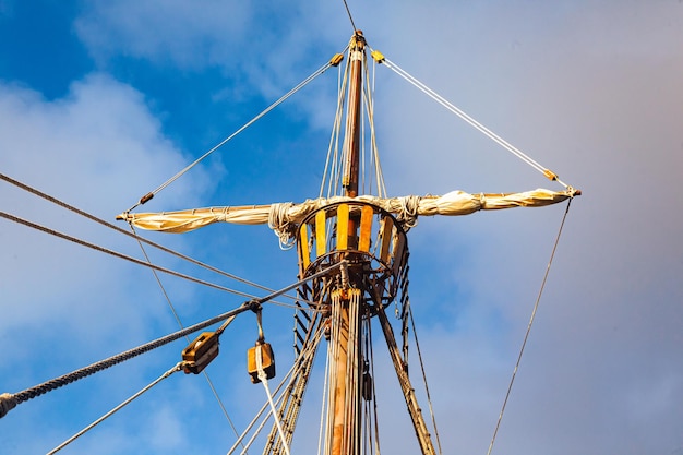 Mast with ropes and ladder on an old wooden ship bottom view