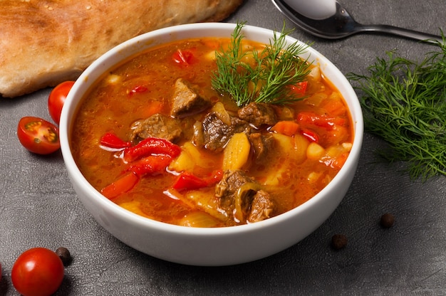 Mastava is a traditional Uzbek soup in a white bowl