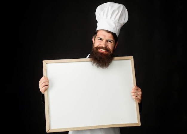 Master chef, baker or cook with menu blackboard. Cooking, culinary, advertisement and food concept.