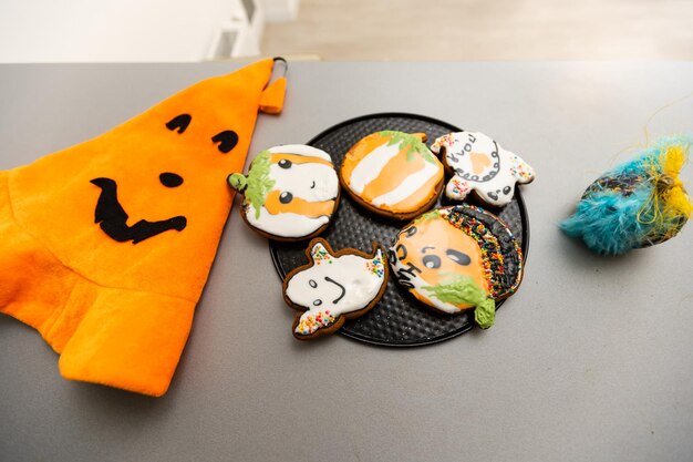 Master class for children on baking funny halloween cookies. Young children learn to cook a funny monster cookies. Kids preparing homemade cookies. Little cook.