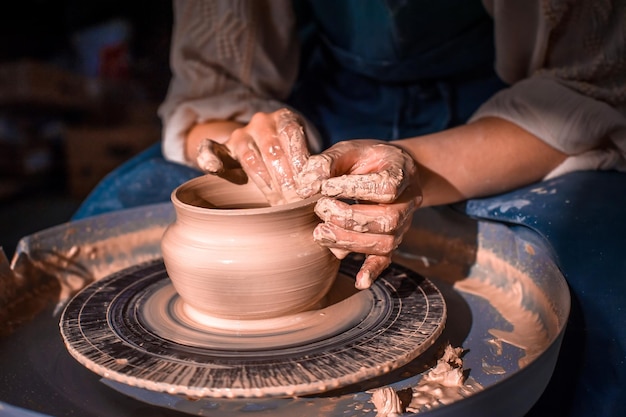 Master class on modeling of clay on a potter's wheel In the pottery workshop