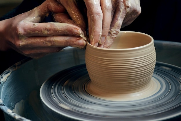 Master class on modeling of clay on a potter's wheel In the pottery workshop