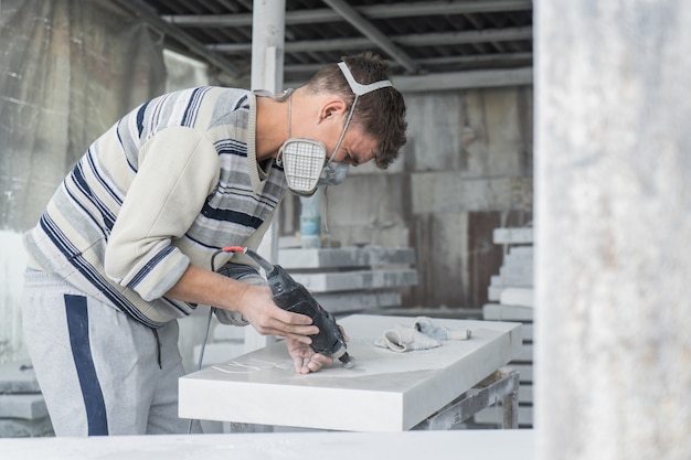 The master engraves the tombstone. Stone processing