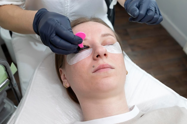 Photo master glues eyelashes to lash silicone roller by applicator eyelash care treatment