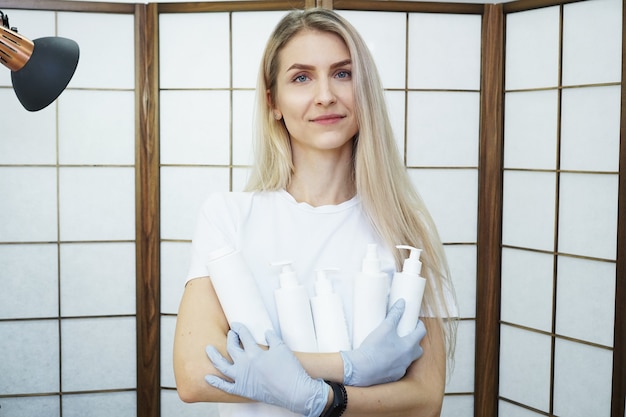 Master holds set of cosmetics white bottles 