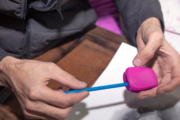 master of a master in pink shirt blue gloves and a black leather bag with a small toy