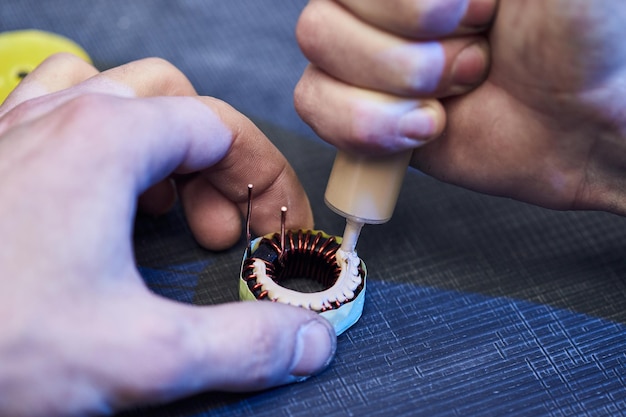 The master specialist makes electromagnetic coils for computer devices