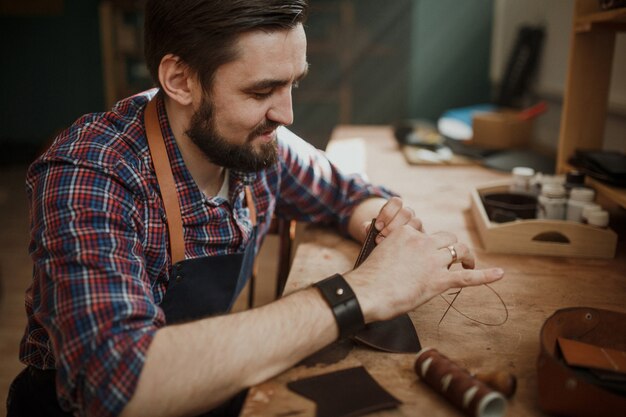 Master tanner works in workshop