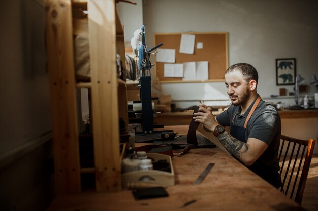 Master tanner works in workshop