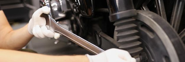 Master unscrews brake discs on the motorcycle with wrench motorcycle repair concept