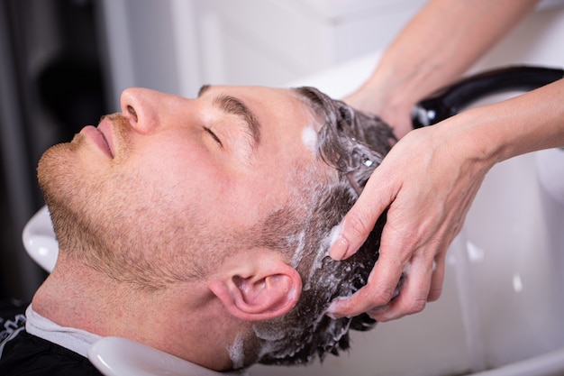 Master washes the head of the client in the Barber shop