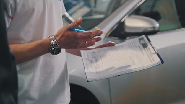 Master and worker checking car - garage auto service - small business, close up