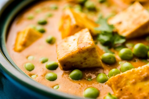 Matar paneer curry recipe made using cottage cheese with green peas, served in a bowl. selective focus