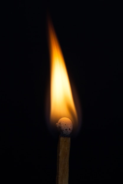 Photo match and blaze of fire on match isolated on black background