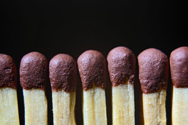 Match heads on a black background close-up.