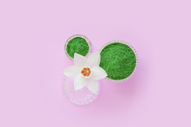 matcha dry green powder on a pink surface for making Japanese natural tea.