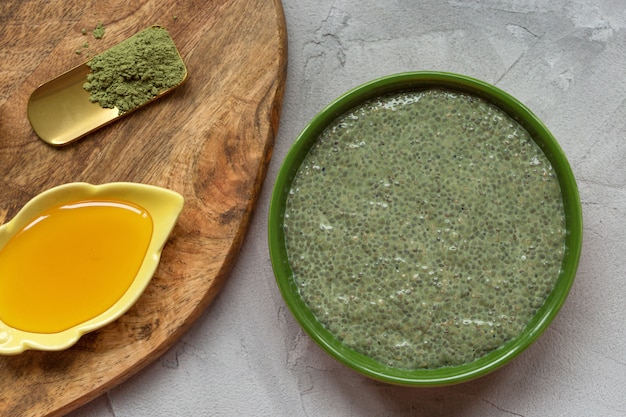 Matcha green tea chia seed pudding bowl and honey. 