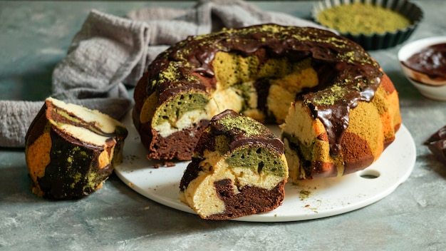 Matcha green tea and chocolate cake on grey background