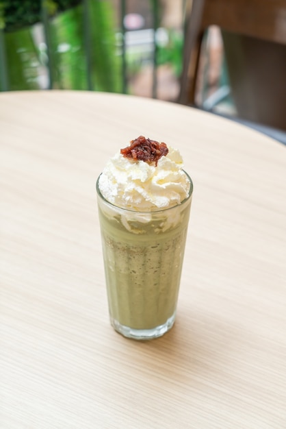 Matcha green tea latte blended with whipped cream and red bean in coffee shop cafe and restaurant