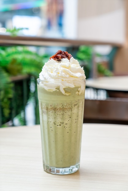 matcha green tea latte blended with whipped cream and red bean in coffee shop cafe and restaurant