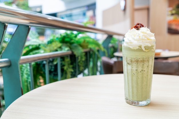 matcha green tea latte blended with whipped cream and red bean in coffee shop cafe and restaurant