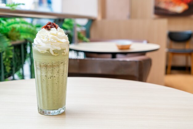 matcha green tea latte blended with whipped cream and red bean in coffee shop cafe and restaurant