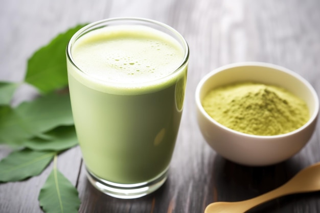 Matcha latte in the foreground matcha tea leaves in the background