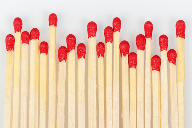 matches with a red head on a white background