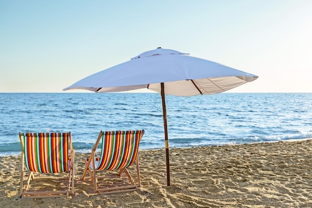 Matcheswooden chaise longue chairs on beach