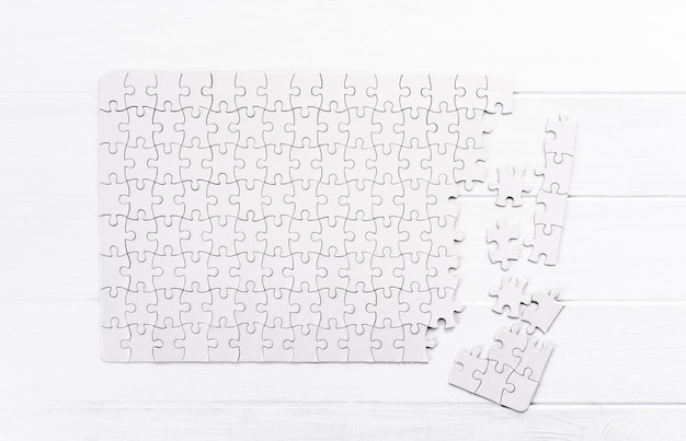 matching pieces of empty puzzle on white background