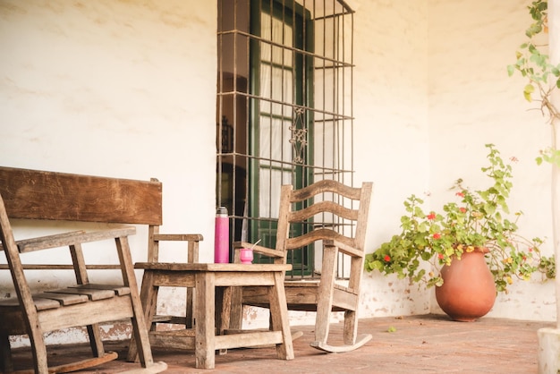 mate and hot water thermos in old room with hammock chairs