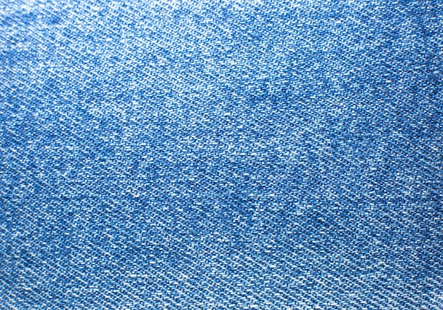 Materiaal blauwe hipsterjeans. Denim doek textuur achtergrond.