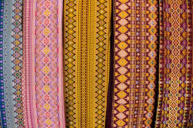 Material silk fabric and raw hand woven cotton with ancient pattern and antique design texture for show and sale in handmade crafts market fair and studio workshop at Bitec Bangna in Bangkok Thailand