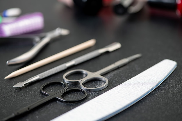 materials for the care of nails, varnishes and devices on a black table