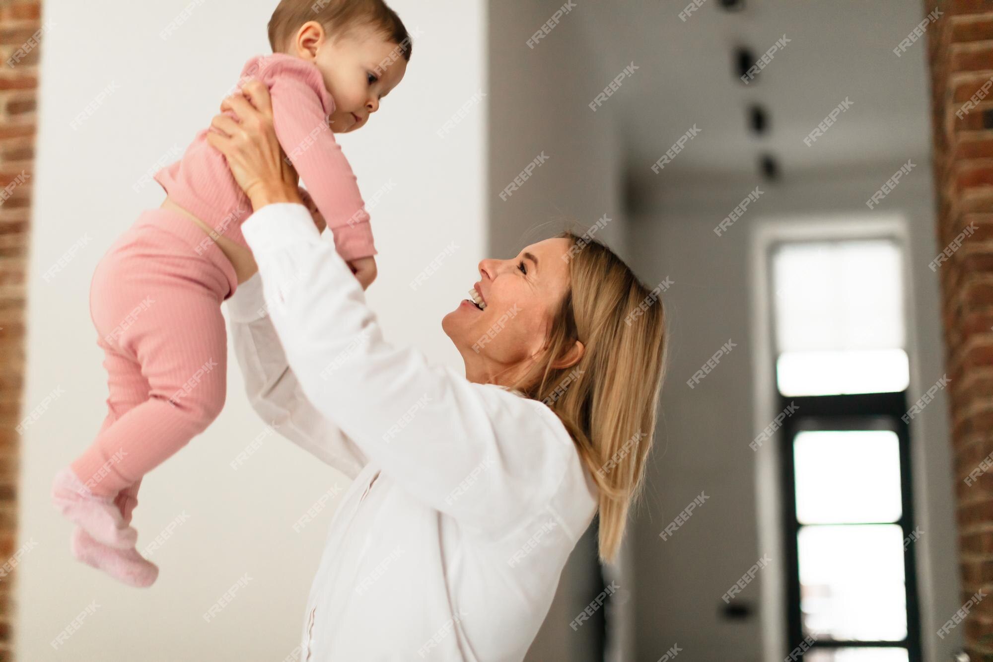 Premium Photo | Maternity leave concept happy woman enjoying time with her  baby girl playing with child and lifting her up in the air