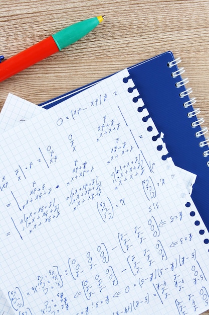 Photo math on copybook page on a wooden table