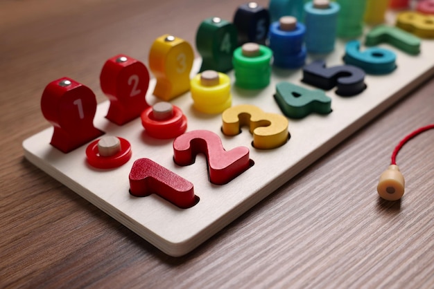 Math game Fishing for Numbers on wooden table closeup