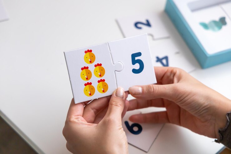 Photo math puzzle for young children two cards in a woman's hand