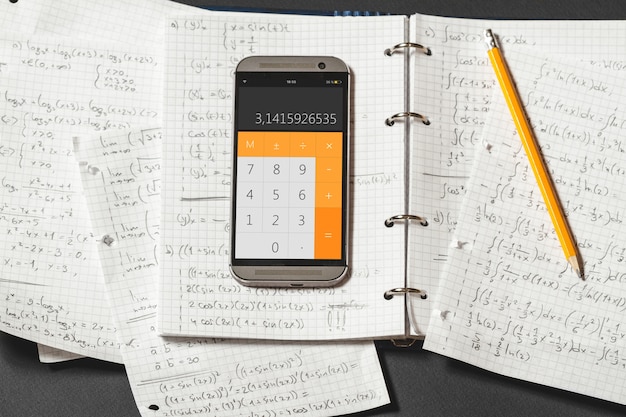 Mathematical equations are written in a notebook