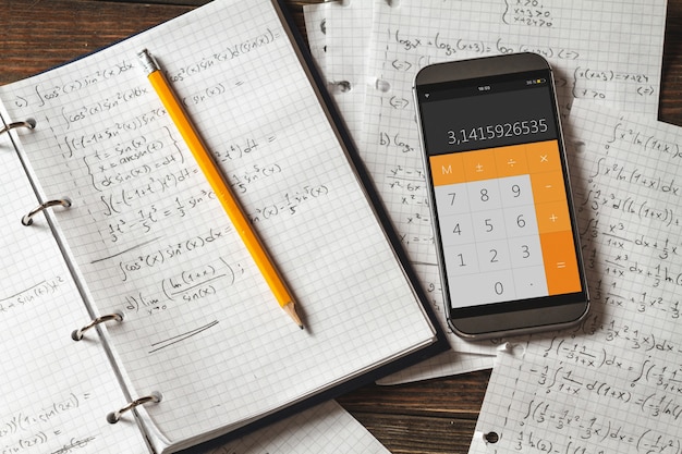 Mathematical equations written in a notebook. Calculator app.