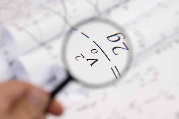 Photo mathematical formulas through a magnifying glass