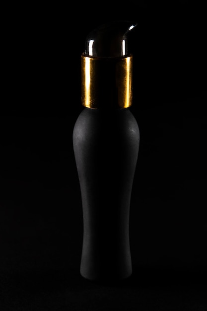 Matt black bottle with dispenser and golden relief